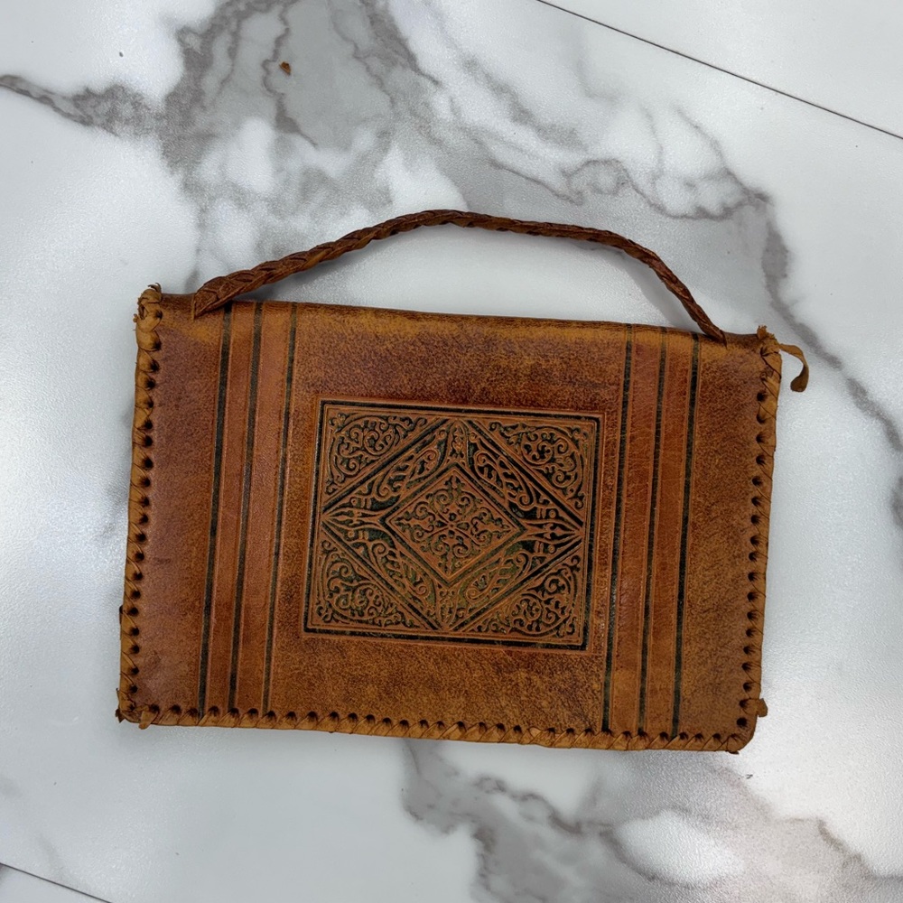 Aged brown leather wallet. Torn pocket.